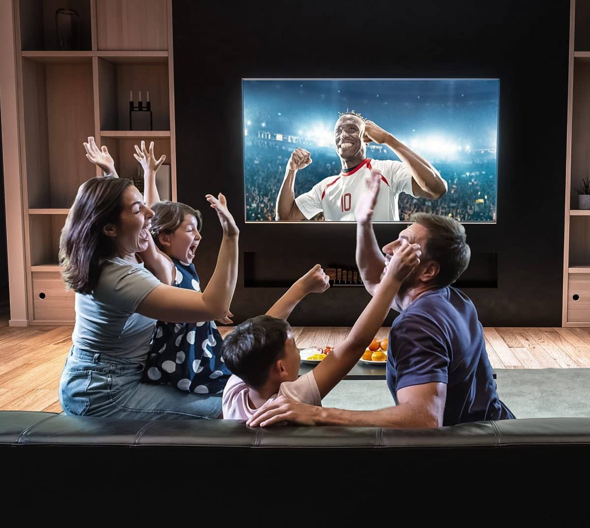 a,family,is,watching,a,soccer,moment,on,the,tv